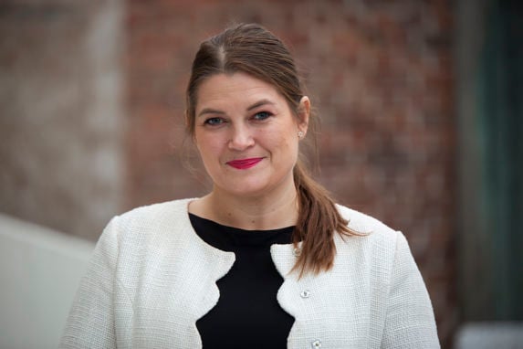 Portrait of Minister of Fisheries and Ocean Policy, Cecilie Myrset wearing a black top and a white jacket. 