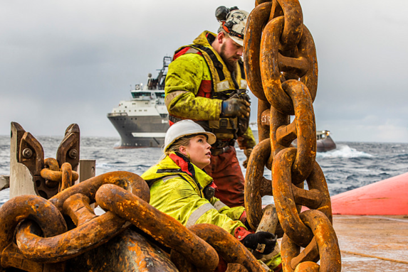 One male and one female working on the deck of an AHTS 